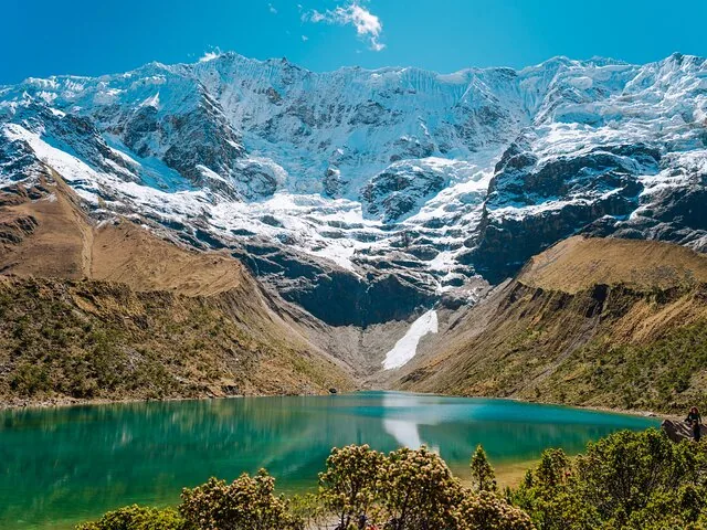 Panoramic landscape of Humantay Lake and snow-capped Andean mountains